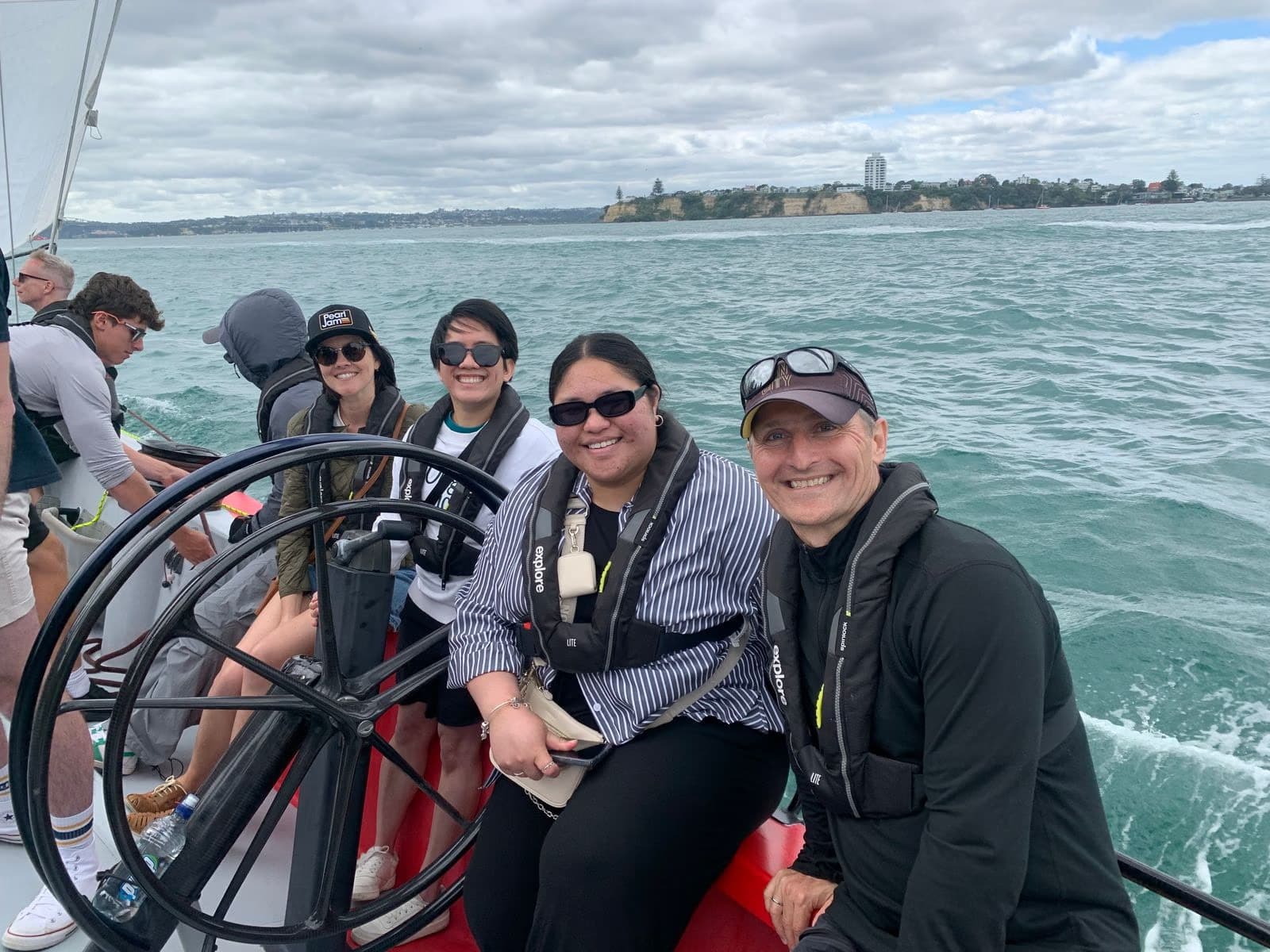 The team out sailing on the Waitematā Harbour